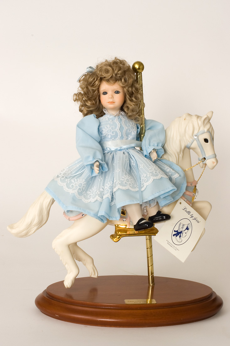 porcelain doll on carousel horse