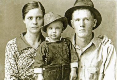 Photo of Elvis Presley at 2 years with mother and father c. 1937.